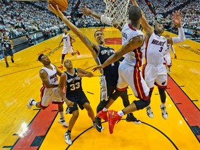 The Heat’s Chris Bosh and Dwyane Wade can’t stop a layup by Spurs’ Danny Green during Game 3 on Tuesday night in Miami. (USA TODAY SPORTS)