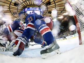 New York Rangers centre Derek Stepan pushes the puck underneath goalie Henrik Lundqvist during Game 4 of the Stanley Cup final against the Los Angeles Kings at Madison Square Garden in New York, June 11, 2014. (BRUCE BENNETT/Pool/USA Today)