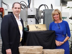 Paul Hazzard, general manager, South West Ag Partners Inc. poses with Judith Morris, president and CEO, Lambton College in front of a dedication plaque to honour South West Ag’s financial contribution to Enactus Lambton’s One Seed Project. Lambton College will be dedicating a room on campus to South West Ag as a token of appreciation.