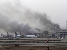 Smoke billows from Jinnah International Airport in Karachi in this June 9, 2014 file photo. REUTERS/Athar Hussain/Files