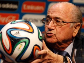 FIFA President Sepp Blatter holds an official 2014 FIFA World Cup soccer ball during a media conference in Sao Paulo June 5, 2014. (REUTERS/Paulo Whitaker)