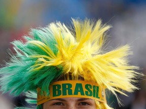 A supporter of Brazil's national soccer team arrives for the opening match of the soccer World Cup between Brazil and Croatia at the Arena de Sao Paulo in Sao Paulo June 12, 2014. (REUTERS/Kai Pfaffenbach)