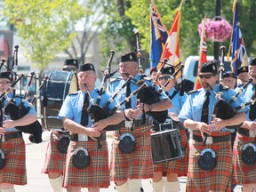The Royal Canadian Legion Pipe Band marches through the street of Lacombe during the Canada Day parade. Lacombe is a small city 125 km south of Edmonton.