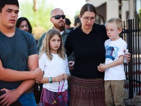Parishioners pray outside the Mater Misericordiae (Mother of Mercy) Mission Catholic church in Phoenix, Arizona June 12, 2014.  A 29-year-old priest was shot dead and another injured during what police described as a burglary at the Catholic church late on Wednesday, authorities said. 

REUTERS/Nancy Weichec