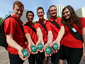 The Downtown Core Crew shows the portable ashtrays they are handing out at Churchill Square.  The City of Edmonton is launching their summer cigarette litter enforcement and education campaign in front of city hall in Edmonton, Alta., on Monday, June 12, 2014.  Perry Mah/Edmonton Sun