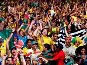 Brazilian soccer fans react while watching the opening World Cup match between Brazil and Croatia in Recife, June 12, 2014. (YVES HERMAN/Reuters)