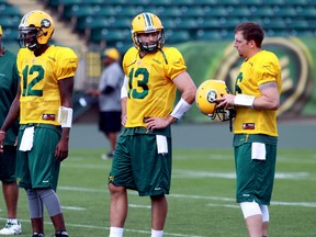 Quarterbacks Jacory Harris, left, Mike Reilly and Matt Nichols chat during training camp earlier this week. (Perry Mah, Edmonton Sun)