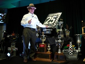 Team owner Jack Roush poses for photographs in front of some of his trophies during the NASCAR Media Tour in Concord, North Carolina January 24, 2012.  (CHRIS KEANE/Reuters)