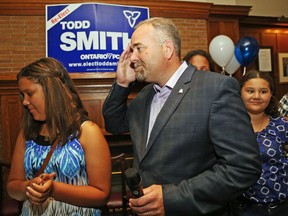 Luke Hendry/The Intelligencer
Progressive Conservative incumbent Todd Smith touches his brow Thursday night at the Belleville Club after winning a second term representing Prince Edward-Hastings. Flanking him are his daughters Payton, left, and Reagan; behind him is his wife, Tawnya.