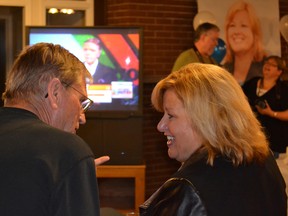 Lisa Thompson talks with volunteer Wayne Douglas while watching the results from the 2014 Ontario provincial election come in on television at the Wingham Golf and Curling Club.