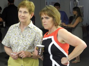 Sarnia-Lambton Liberal candidate Anne-Marie Gillis (right) intently watches results pour in with supporter Marylin Chiles on election night. (SHAUN BISSON, The Observer)