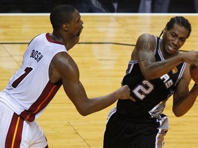 San Antonio Spurs' Kawhi Leonard (R) keeps the ball away from Miami Heat's Chris Bosh during the second quarter in Game 4 of the NBA Finals on June 12. (Reuters)