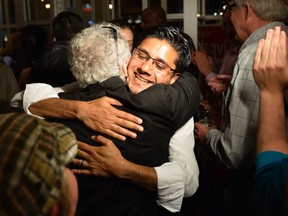 Ottawa Centre Liberal incumbent Yasir Naqvi hugs a supporter while celebrating his win in the Ontario provincial election in Ottawa on Thursday, June 12, 2014. 
Matthew Usherwood/Ottawa Sun