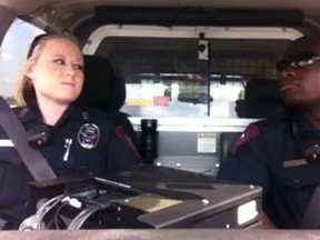 Rosenberg police officers Aerial Ronell and Ranell Roy are pictured in their cruiser in this screengrab.