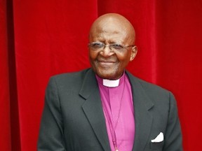 South African Archbishop and Nobel peace laureate Desmond Tutu poses as he arrives for a photocall for the documentary