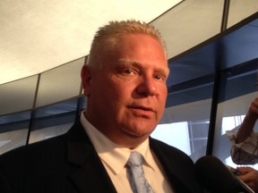 Councillor Doug Ford speaks to reporters at City Hall on Friday. (DON PEAT/Toronto Sun)