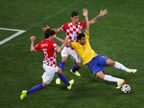 Brazil's Fred is fouled by Croatia's Dejan Lovren inside the area during their 2014 World Cup opening match at the Corinthians arena in Sao Paulo June 12, 2014. (REUTERS/Paulo Whitaker)