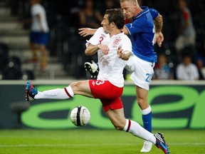 Italy's Ignazio Abate (R) fights for the ball with England's Leighton Baines during their international friendly soccer match on Aug. 15, 2012. (Reuters)