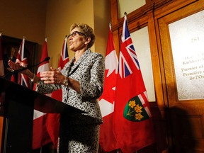 Ontario Premier Kathleen Wynne speaks to media in front of her office at Queen's Park in Toronto the morning after her government was re-elected with a majority on Friday, June 13, 2014. (MICHAEL PEAKE/Toronto Sun)