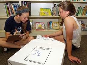Grade 7 students Emma Howson, left, and Kaitlyn Ransome count ballots after the student vote at Prince of Wales Public School in Belleville Tuesday, June 10. 
Luke Hendry/The Intelligencer