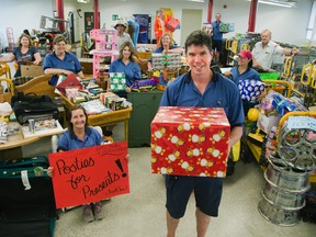 Posties For Presents volunteers with items to be sold during a yard sale at the Canada post building 955 Highbury on Saturday, June 14. L to R Sarah Perry, Toni Demelo, Terri Martin, Mike Dalgleish, Olga Nethersole, Lenora Marple, Kellie Stark, Brandon Brockman, Cam Polley, Kelly Gil and Bill McKerlie. Photo shot in London, Ontario on Friday, June 13, 2014. DEREK RUTTAN/ The London Free Press /QMI AGENCY