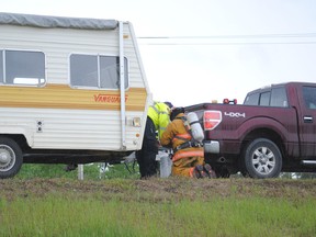 Deputy Fire Chief Troy Dufort and another fire fighter inspect a propane tank that was dragged along the road after it came loose from its mount from a recreational trailer that was traveling on Highway 43 on Tuesday, June 10.
Barry Kerton | Whitecourt Star