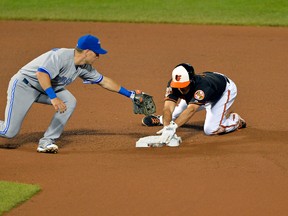Baltimore Orioles shortstop J.J. Hardy (2) slides under Toronto Blue Jays second baseman Steve Tolleson (18) for a double during sixth the inning  at Oriole Park at Camden Yards on Jun 13, 2014 in Baltimore, MD, USA. (Tommy Gilligan-USA TODAY Sports)