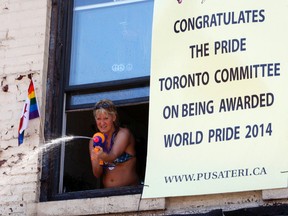 A sign at the 2011 Toronto Pride parade, sponsored by Pusateri Fruit Market, congratulates organizers on being awarded the World Pride event. (Michael Peake/Toronto Sun)