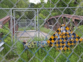 The Cull Drain Bridge, pictured here, has been fenced off from the public since the fall of 2012. City staff are expected to present a $1-million estimate to council to restore the bridge with the cost of replacement expected to be less than half of that. BARBARA SIMPSON/THE OBSERVER/QMI AGENCY
