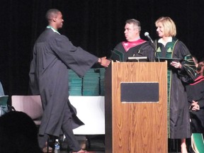 One of the roughly 1,600 new graduates at Lambton College walking across the stage to accept his diploma on Saturday.