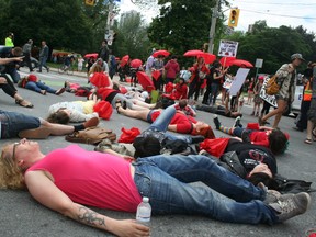 Protesters 'play dead' at the intersection of Sherbourne St. and Gerrard St. E. on June 14, 2014. They are calling for the end of Bill C36, proposed legislation that would mean new prostitution prohibitions placed in Canada's law books. (Terry Davidson/Toronto Sun)