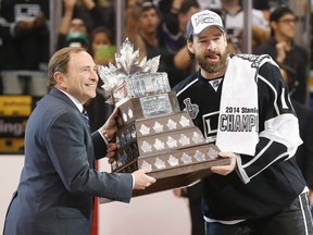 Justin Williams is award the Conn Smythe Trophy on Friday night by NHL commissioner Gary Bettman. (Gary A. Vasquez/USA TODAY Sports)