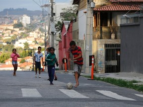 Kids play soccer on a street outside Independencia stadium before the start of the Argentine national team training session in preparation for 2014 World Cup in Belo Horizonte, June 11, 2014. (REUTERS/Leonhard Foeger)