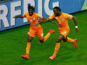 Ivory Coast's Gervinho (L) and Didier Drogba celebrate their goal against Japan during their 2014 World Cup Group C soccer match at the Pernambuco arena in Recife June 14, 2014. (REUTERS/Ruben Sprich)
