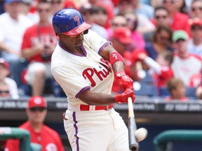 Philadelphia Phillies shortstop Jimmy Rollins (11) hits a home run in the first inning against the Cincinnati Reds at Citizens Bank Park on May 18, 2014 in Philadelphia, PA, USA. (Bill Streicher-USA TODAY Sports)