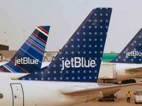 JetBlue Airways aircraft are pictured at departure gates at John F. Kennedy International Airport in New York in this file photo taken June 15, 2013. (REUTERS/Fred Prouser/Files)