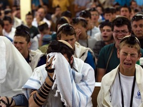 Israeli seminary students take part in a special prayer in the West Bank Jewish settlement of Kfar Etzion June 15, 2014, for three teenagers that were abducted. Two of the teenagers studied at the seminary. Israel said on Sunday Hamas militants had abducted three Israeli teenagers in the occupied West Bank, warning of "serious consequences" as it pressed on with a search and detained dozens of Palestinians. REUTERS/Ronen Zvulun
