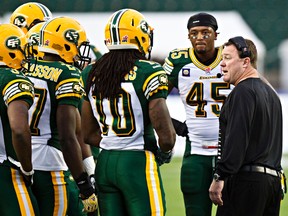 Edmonton's head coach Chris Jones talks to his players during the Edmonton Eskimos' pre-season CFL football game against the B.C. Lions at Commonwealth Stadium in Edmonton, Alta., on Friday, June 13, 2014. Codie McLachlan/Edmonton Sun/QMI Agency