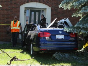 Firefighters, police and paramedics responded to a rollover crash in suburban Kanata Sunday, June 15, 2014. An elderly couple needed to be cut out of their Jetta sedan after it sped into a tree and smashed into the steps to a townhome at the corner of Steeplechase Dr. and Woodbridge Cr.
DOUG HEMPSTEAD/Ottawa Sun/QMI AGENCY