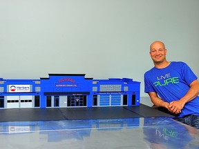 Matt Ferguson poses with a model of the Herbers Building he created. Photod by Dave Steers Photography. (undated supplied photo)