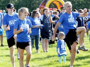 Edmonton Oilers GM Edmonton Oilers Craig  MacTavish (centre) and his children Sean MacTavish (far left) and Brianna MacTavish (2nd from left) take part in a Zumba warm up prior to the start of the Do It For Dad walk and run for prostate cancer in Sir Wilfrid Laurier Park, in Edmonton Alta., on Sunday June 15, 2014. 750 people took part in the event which raised $90,000 for prostate cancer research. David Bloom/Edmonton Sun/QMI Agency