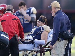 Winnipeg Blue Bombers Graig Newman is taken away on a stretcher during pre-season CFL football in Calgary on Saturday. Newman will miss the entire season, Bomber officials announced Monday. (Al Charest/QMI Agency)