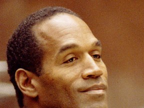 O.J. Simpson smiles in court July 5, 1995 during his criminal trial in Los Angeles.