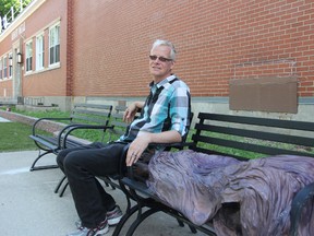 River City Vineyard pastor George Esser sits Monday with the 'Homeless Jesus' statue erected outside of its Harbour Inn Homeless Shelter. Esser and his nephew Aaron Esser helped craft the sleeping Jesus to serve as a public reminder of the homeless while the Mitton Street shelter is closed as the result of a Superior Court order. The church is appealing the decision. (BARBARA SIMPSON/THE OBSERVER/QMI AGENCY)