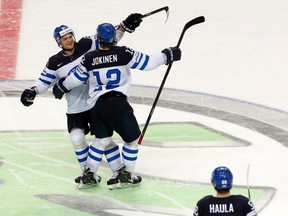 Finland's Iiro Pakarinen (L) celebrates his penalty shoot out goal with team mate Olli Jokinen (R) after the overtime period of their men's ice hockey World Championship Group B game against Switzerland at Minsk Arena in Minsk May 16, 2014. REUTERS/Alexander Demianchuk