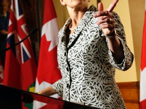 Ontario Premier Kathleen Wynne speaks to media in front of her office at Queen's Park in Toronto Friday, June 13, 2014. Michael Peake/Toronto Sun/QMI Agency