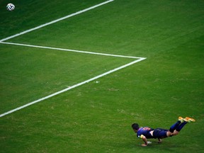 Robin van Persie of the Netherlands heads to score against Spain during their 2014 World Cup Group B soccer match at the Fonte Nova arena in Salvador on June 13, 2014. (REUTERS/Fabrizio Bensch)