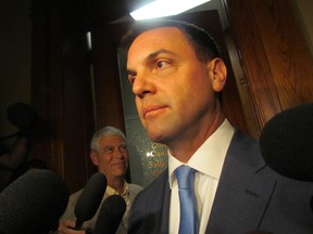 PC Leader Tim Hudak speaks to media after a prolonged grilling from returning and retiring PC MPPs on Monday, June 16 2014. (Antonella Artuso/Toronto Sun)
