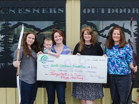 (From Left) Tory Daniels, Hailee Daniels (and son), Executive Directer of Quinte children's foundation Connie Reid, and Carol Armstrong are seen here with the funds raised for Jump Start for kids during the Floyd Armstrong memorial archery tournament. Belleville On. Monday, June 16.   
Lacy Gillott/TheIntelligencer/QMI Agency