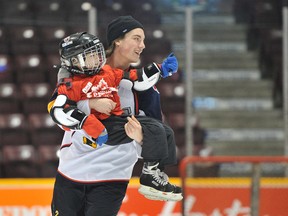 Liam Maaskant of the Barrie Colts gives Logan McConnachie, 6, a lift during the Courage Canada skating event at the Barrie Molson Centre in February. McConnachie, who was born with optic nerve damage, joined dozens of other visually impaired children for the event. (Mark Wanzel/QMI Agency)